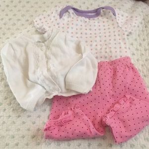 White cardigan, flower onesie, & polka dot pants.